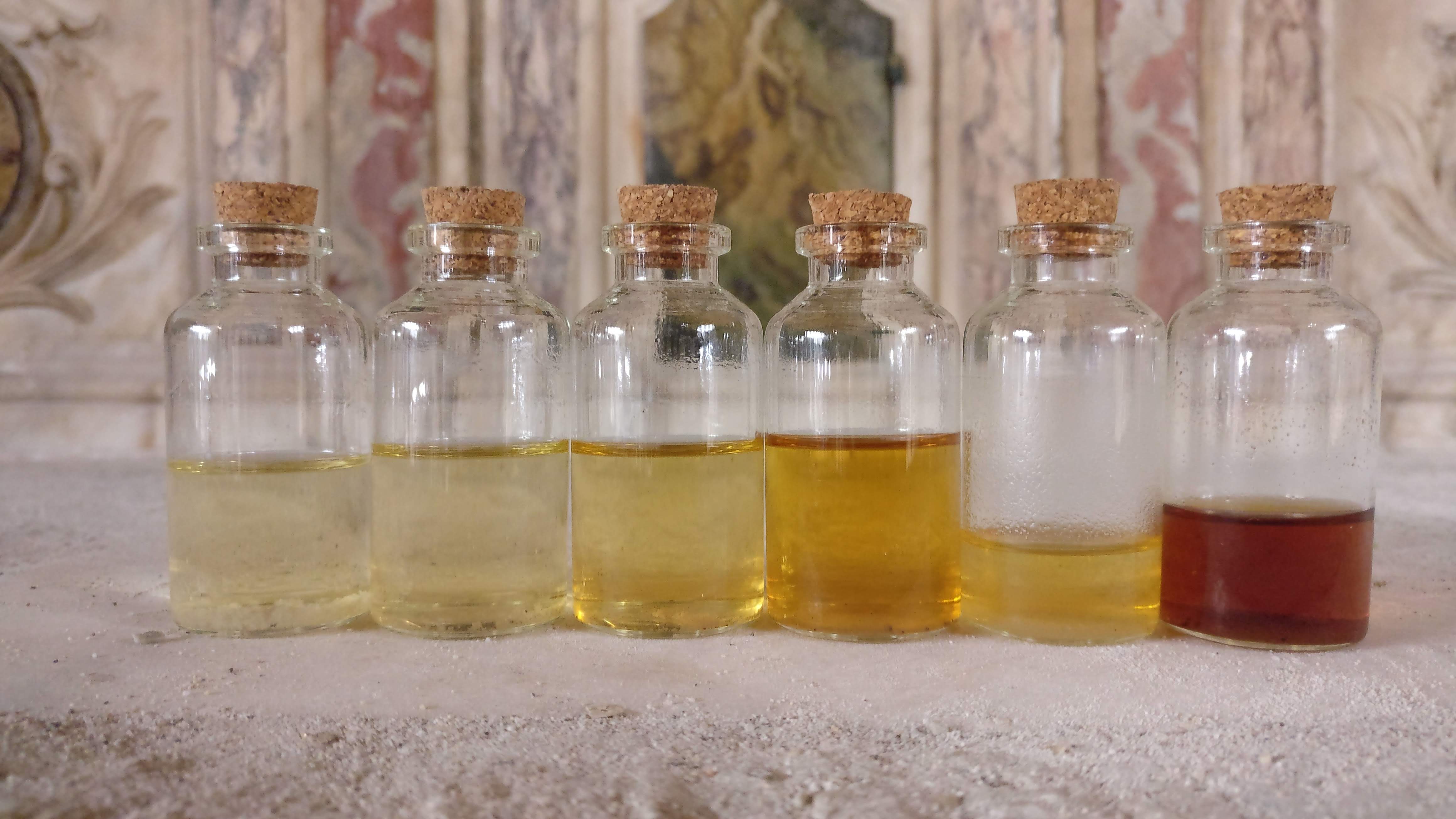 a photo of 6 glass bottles stnading on a marble top inside a venetian church